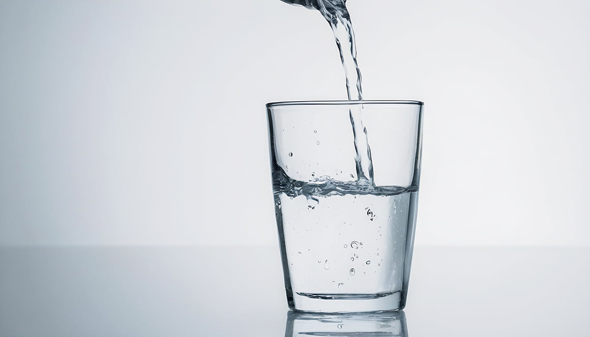 Water-is-poured-into-a-glass-cup.jpg